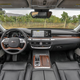 The interior of a Kia K90 sedan with leather trim and wood details